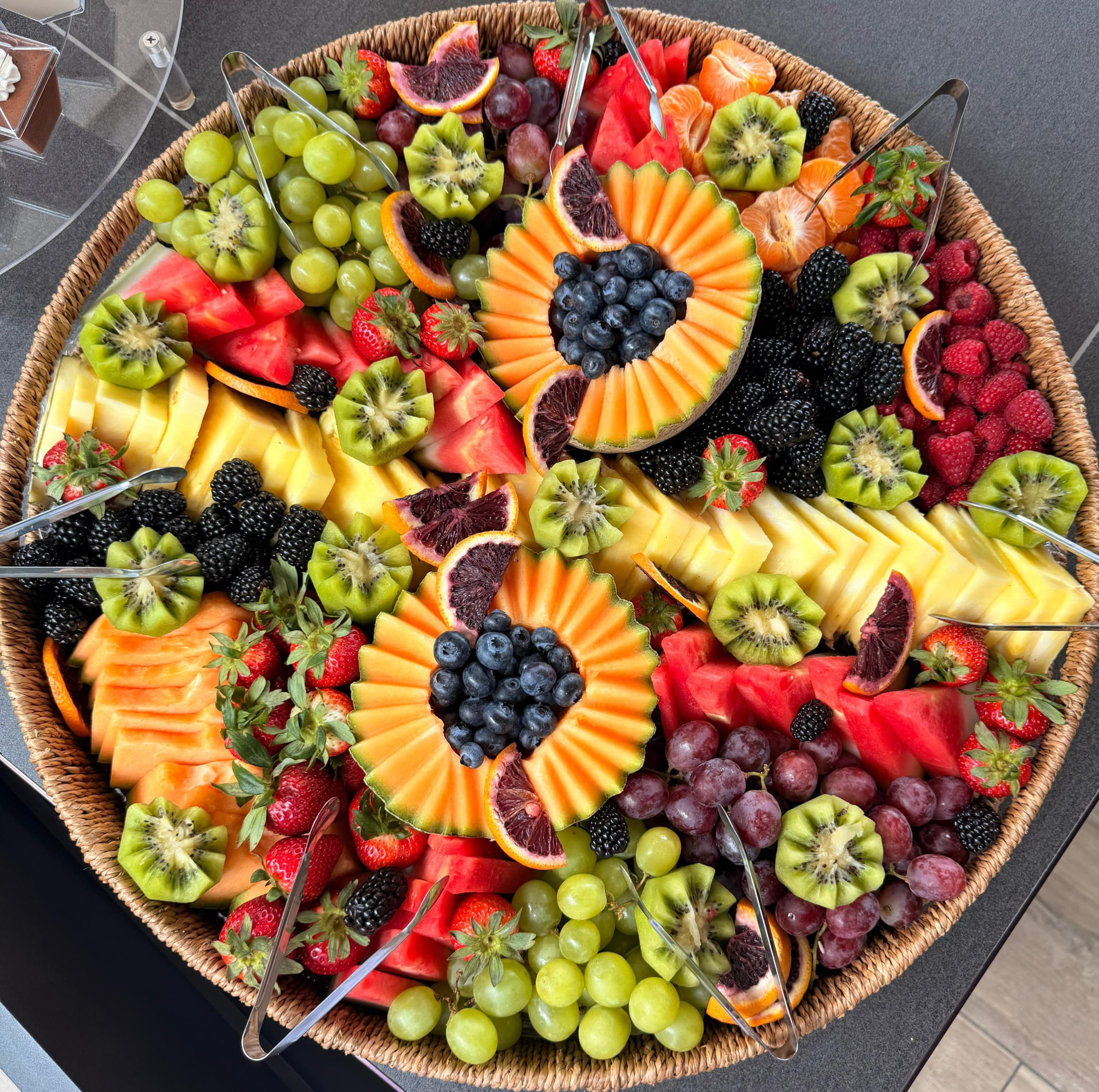 Fresh seasonal fruit platter with melon, berries, pineapple, kiwi and grapes for an Orange County catering spread